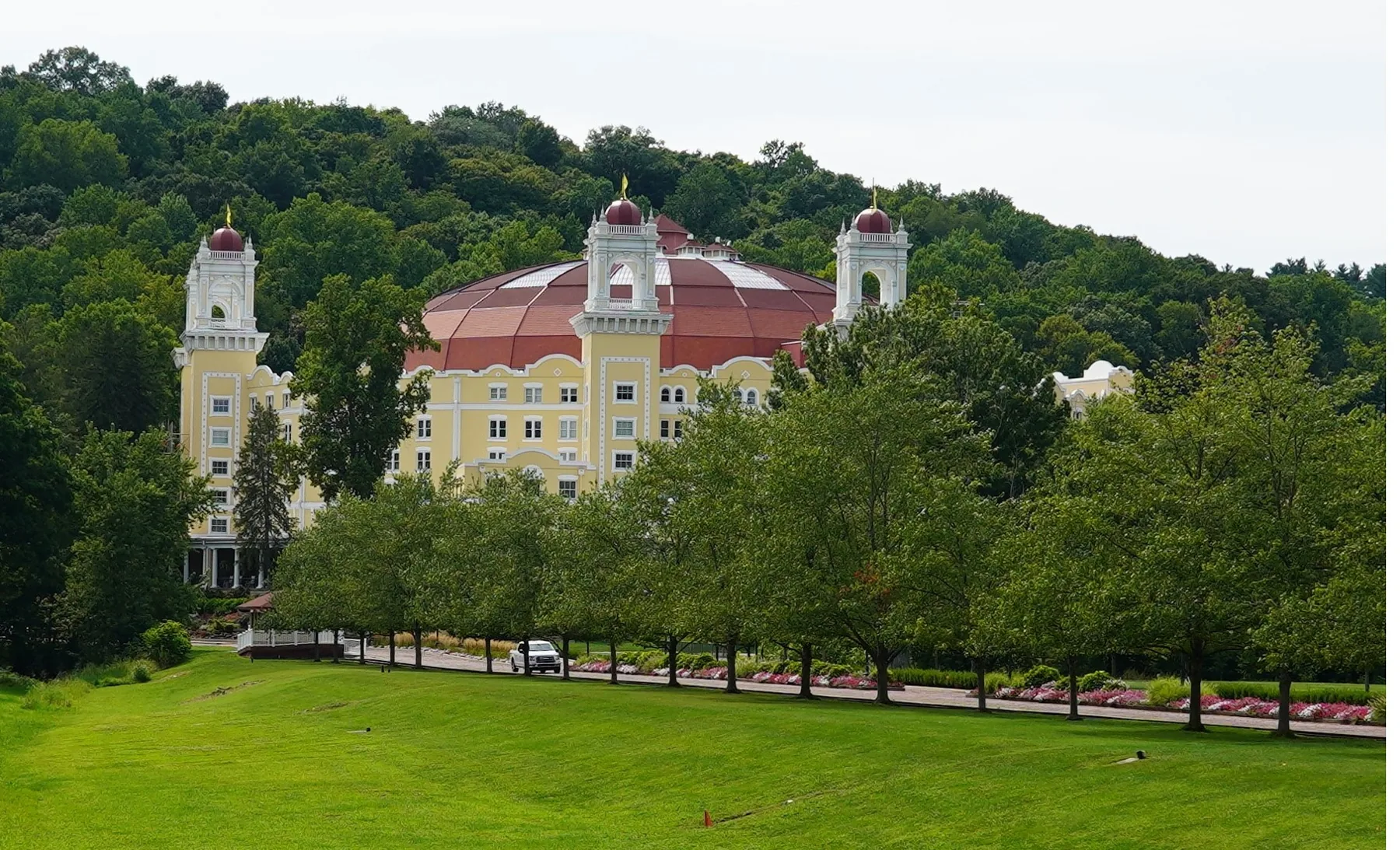 The West Baden Springs Hotel exterior, with its red dome and towers, seen beyond a lawn